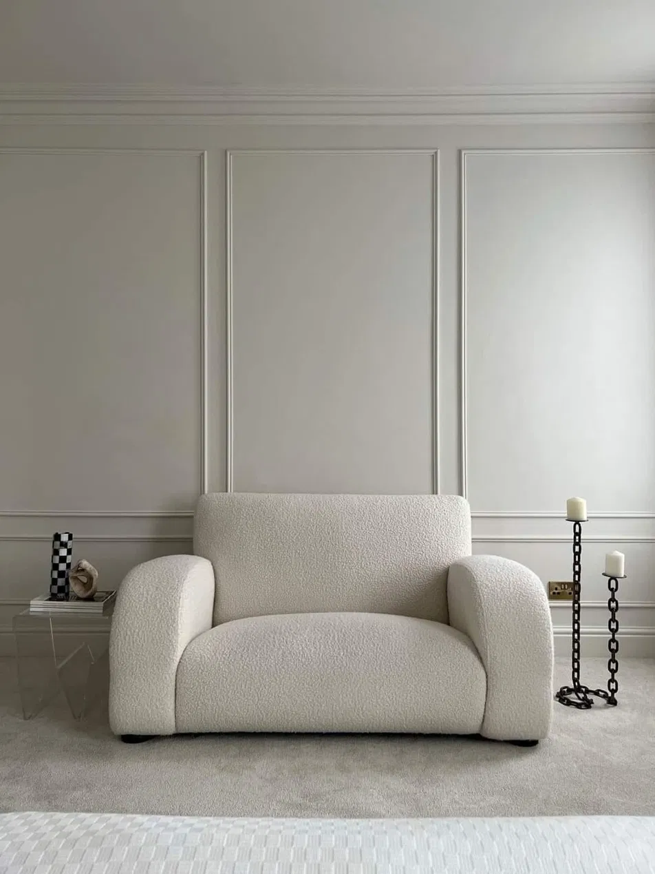 Cream boucle armchair in a neutral interior