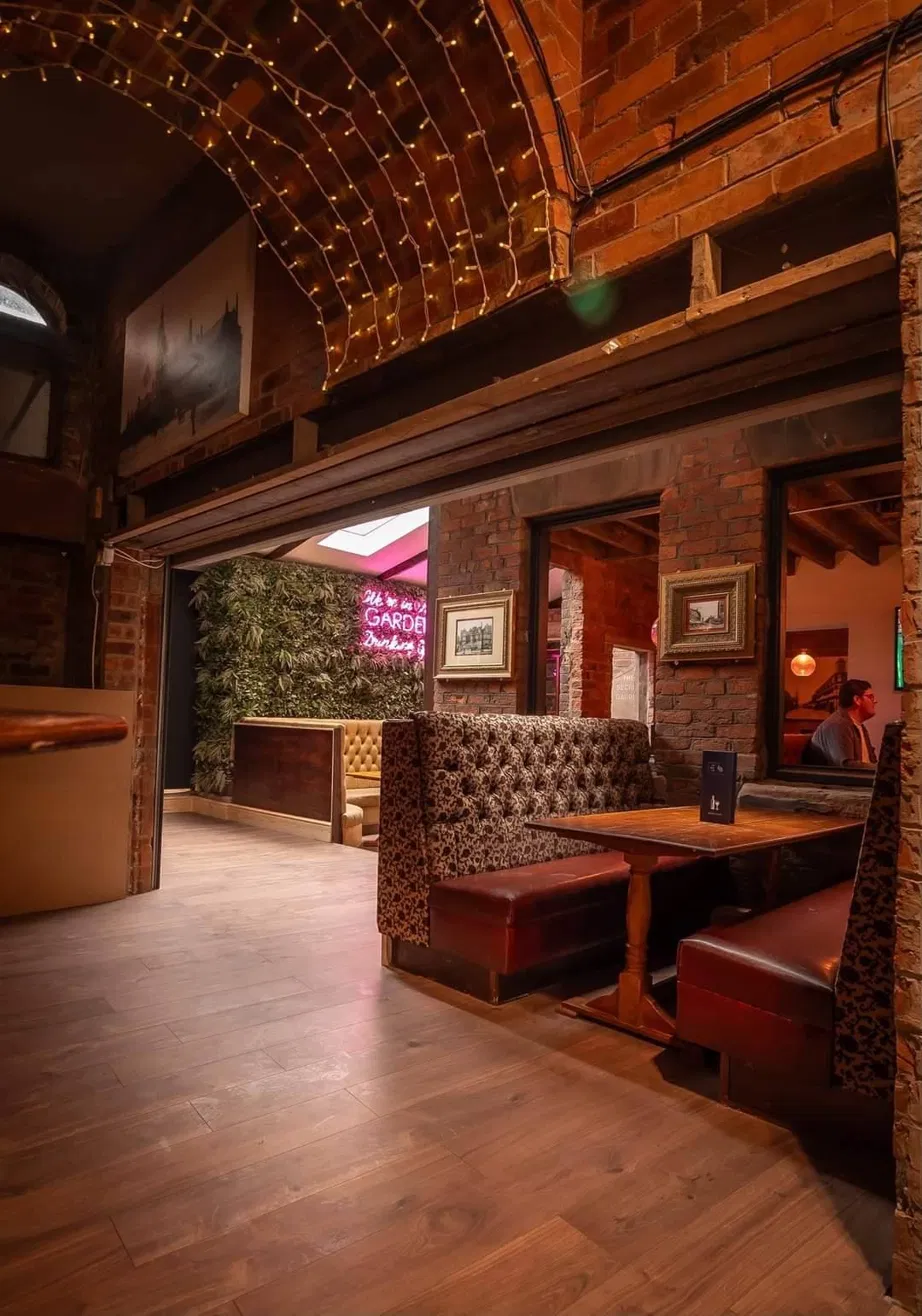 Pub booth seating beneath warm fairy lights