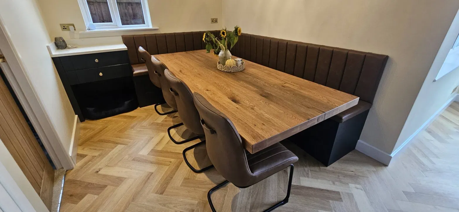 Brown corner banquette dining seating with timber table