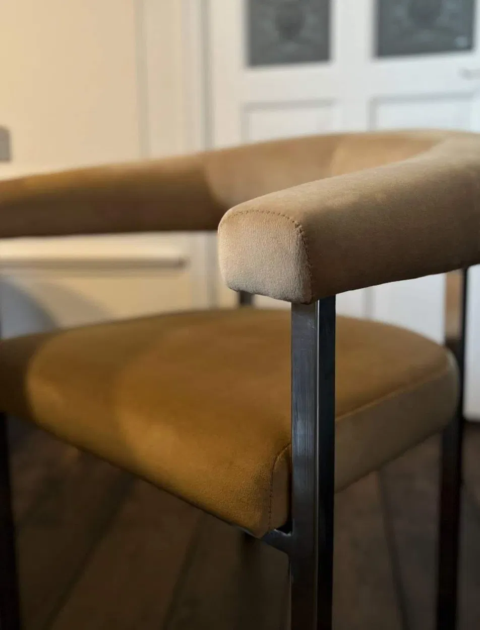 Tan suede upholstered bar stool detail