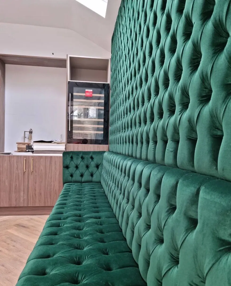 Green tufted velvet banquette wall seating