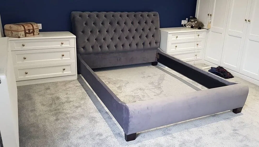 Grey chesterfield upholstered bed frame in a bedroom