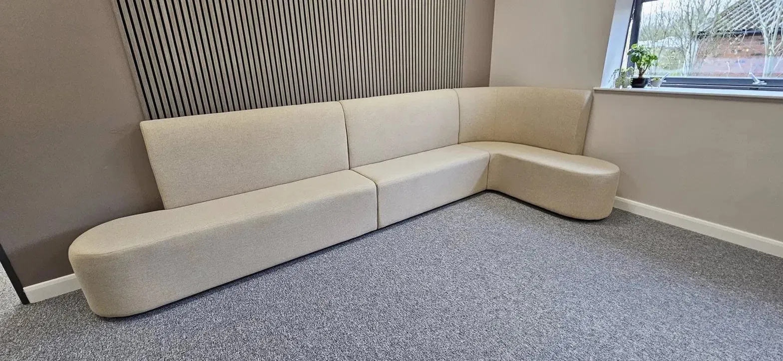 Cream corner L-shaped sofa in an office